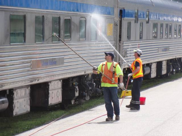 Picture:  Workers wash the train windows in preparation for the mountain views.  Via Rail, Canada