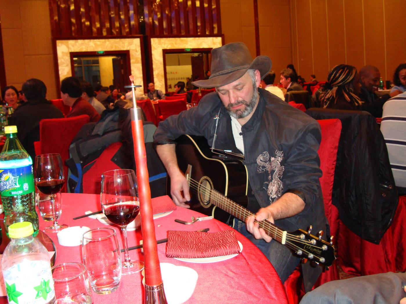 Sean Sartos from New York, one of the Lambton teachers, warms up at our table before contributing to the performances.  The AEFI New Year's Party, Wuxi, China