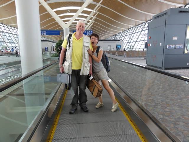 Picture:  Panda hams it up on the moving sidewalk.  Shanghai, China