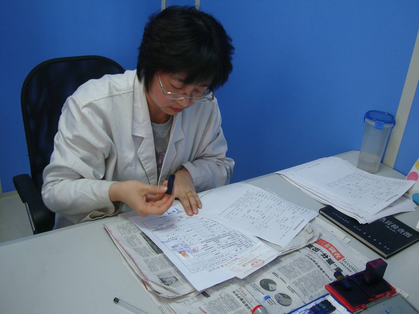 Getting a Chinese driver's license, the necessary red stamps all over the paperwork.  Wuxi, China