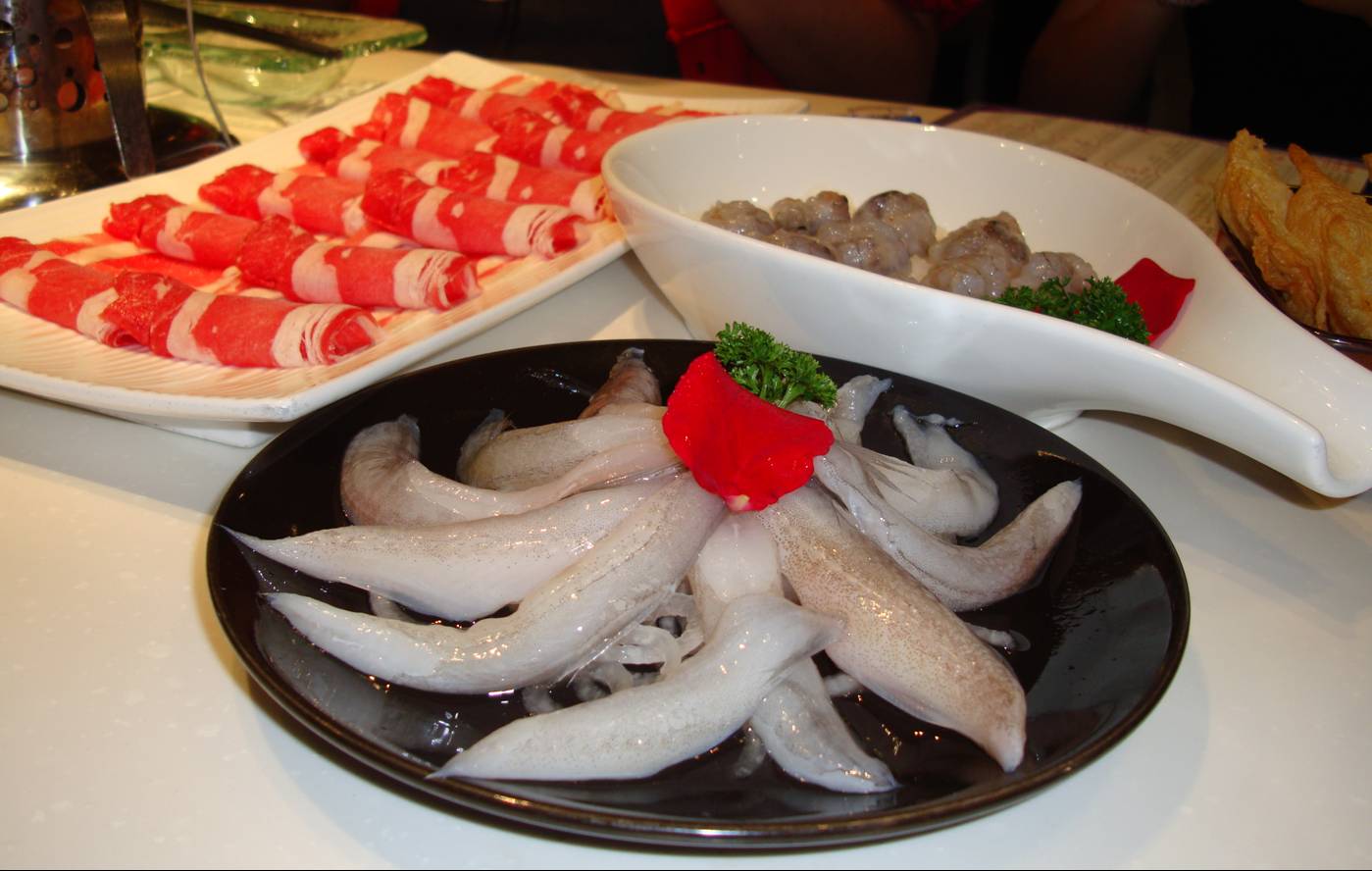 Picture:  Hotpot raw ingredients.  The forground is some kind of fish with tiny edible bones.  Not shown are the tofu, mushrooms, and veggies.  Wuxi, China