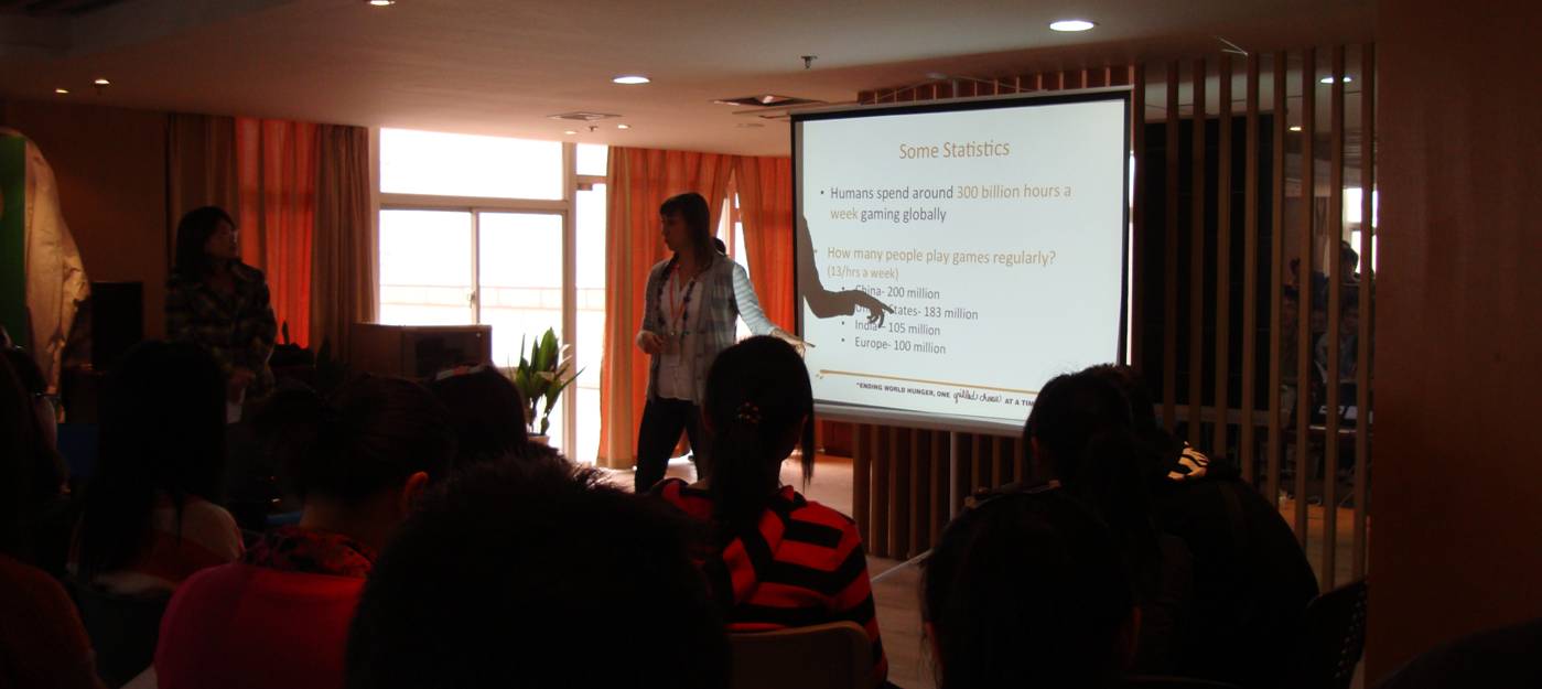 Picture:  Talis describes the principles of computer games that can be applied to volunteering.  Wuxi, China
