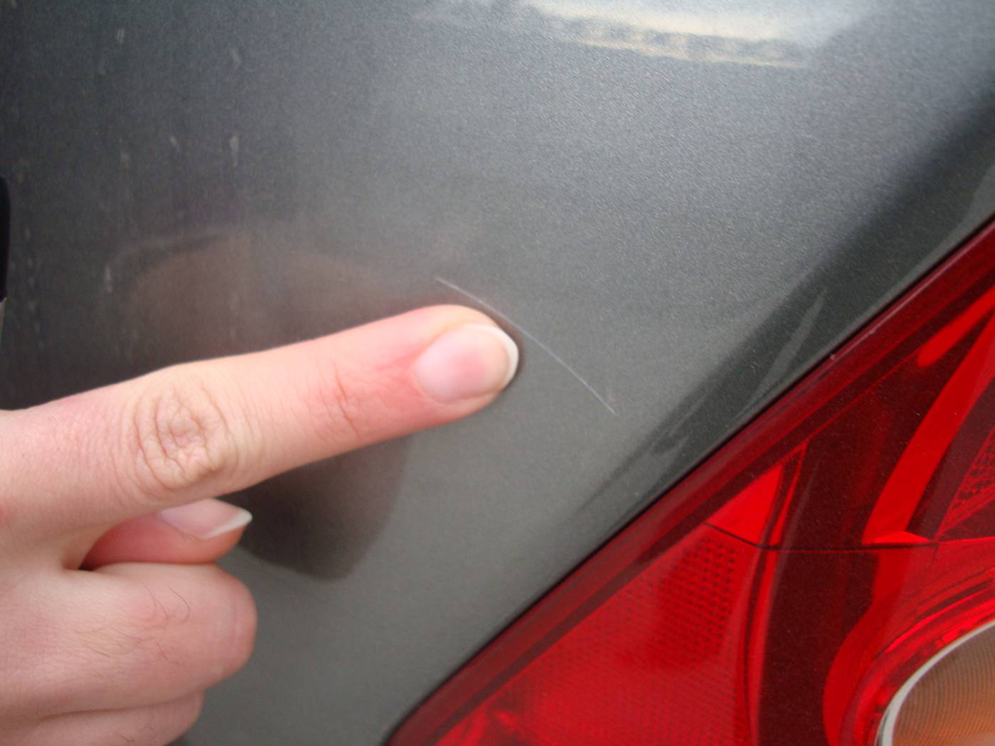 Picture:  The agent points out a scratch on the Honda rental car.  Wuxi, China