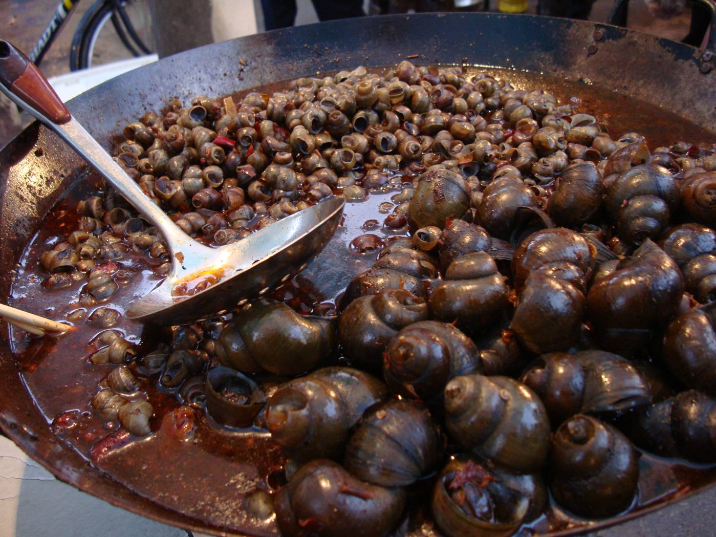 Picture:  A huge pot of tasty snails, just one of the many street foods in Shi Tang Cun.  China