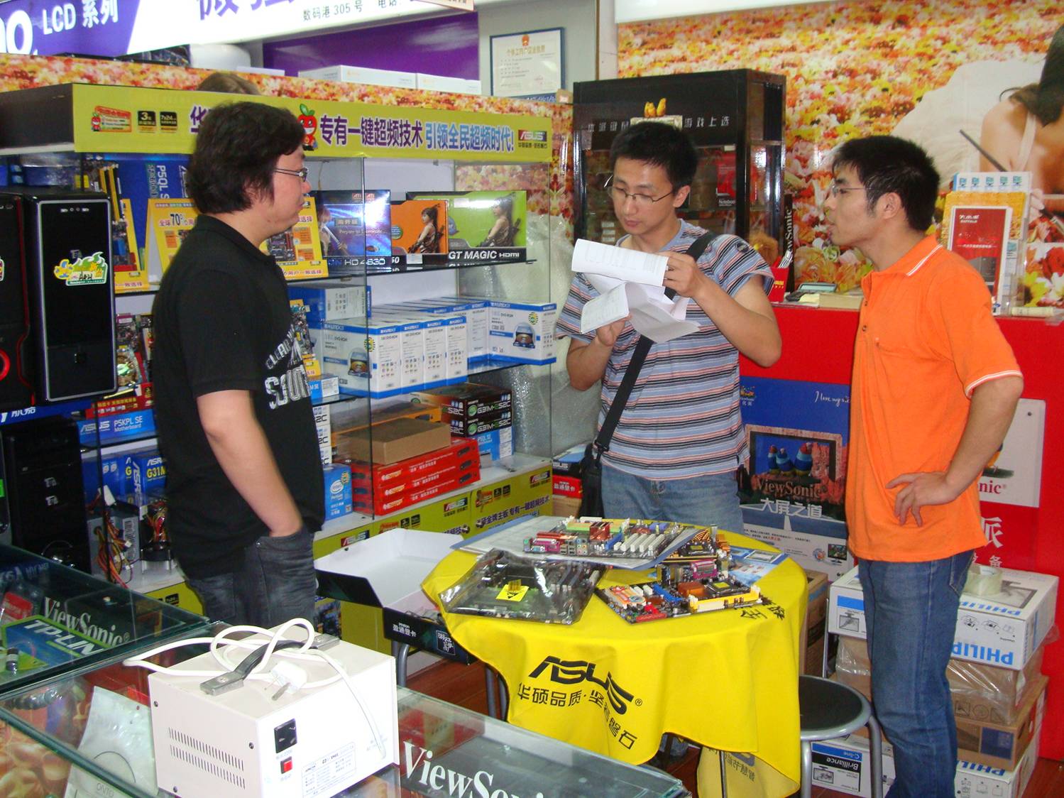 Jin Bo and Wang Xu select components for my new computer.  Wuxi,  China.