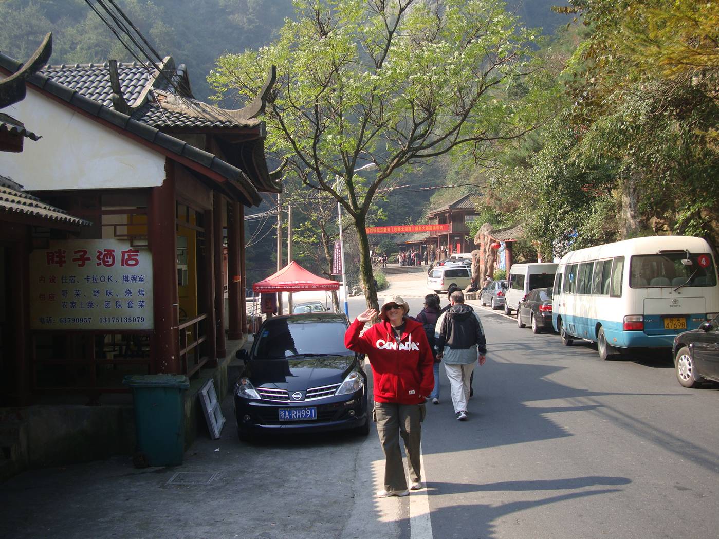 Picture:  Ruth in the sweatshirt my sister Susan gave her back home, standing on a street  in Zhejiang Province, China