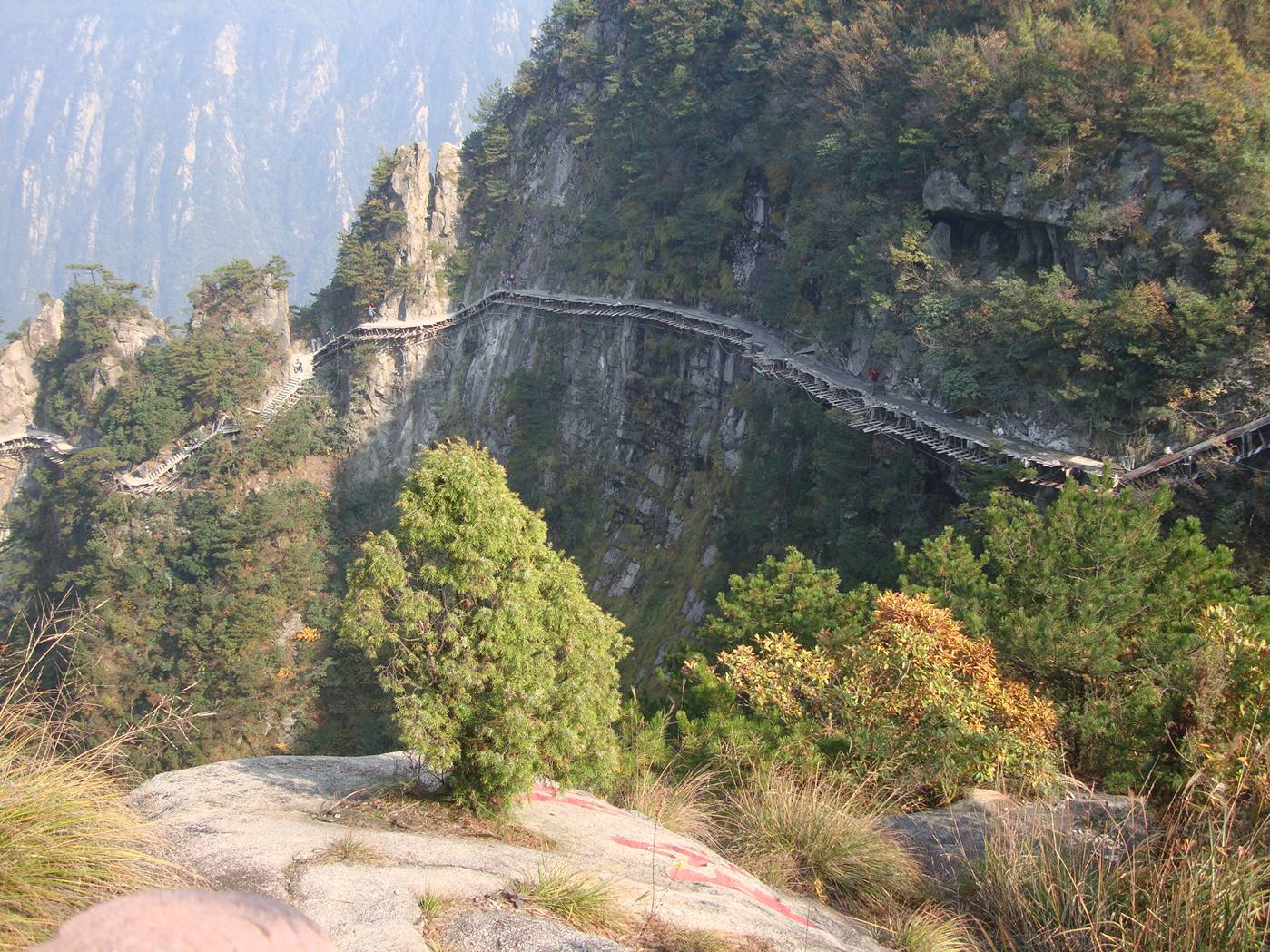 Picture: The mountain side impossible sidewalk under construction.  Daming Shan, Zhejiang, China