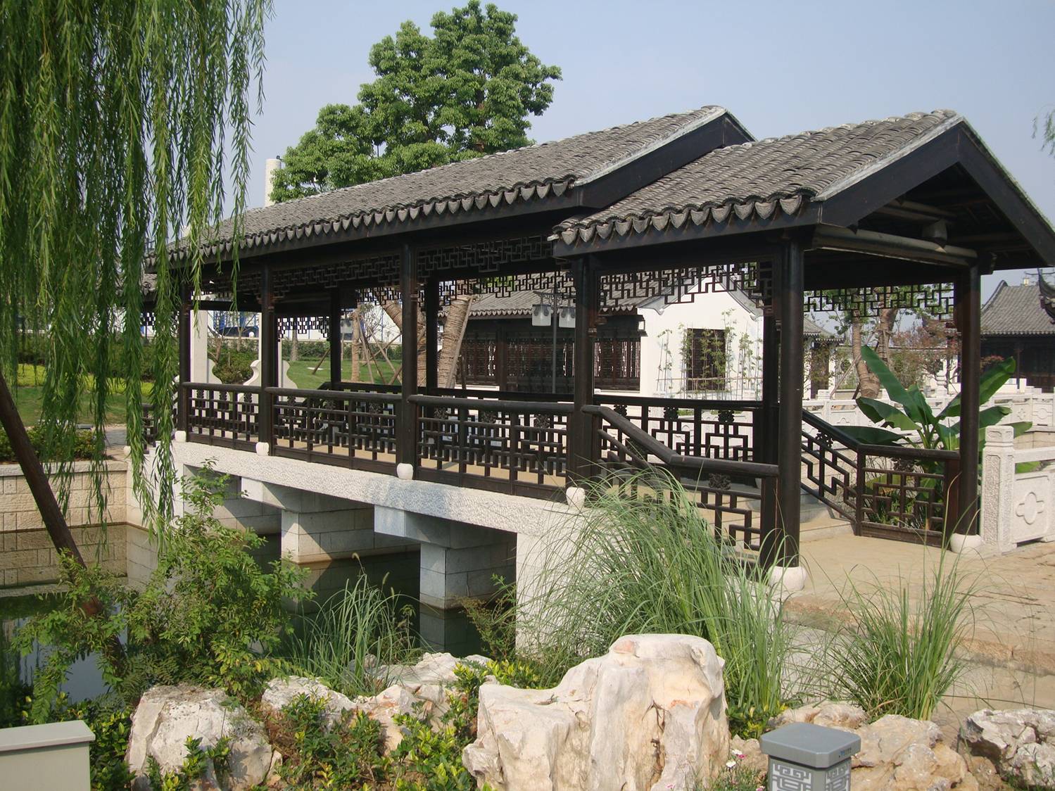 picture:  This foot bridge is classic Chinese.  Just beautiful. Canal side park near Jiangnan University, Wuxi, China