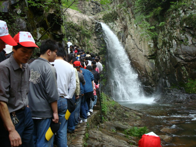 tourists crowd Dongyuan Waterfall,  Wuxie Scenic Area,  Zhejiang Province, China